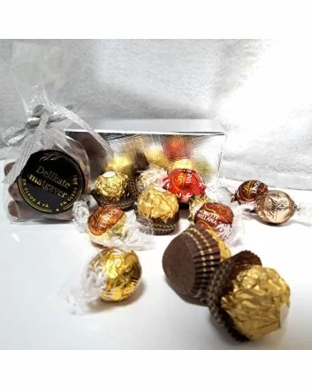 En liten fin pappbox som inneholder sjokolader av lindt og ferrerorocher merket. Boksen er ment for å erstatte den klasisske påskeegget.